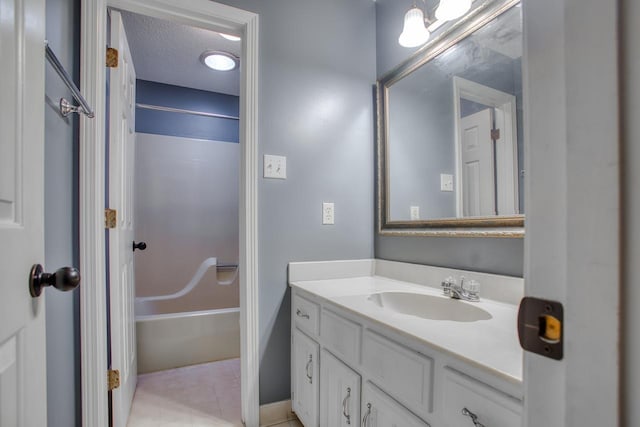 full bathroom with bathtub / shower combination, a textured ceiling, vanity, and tile patterned floors