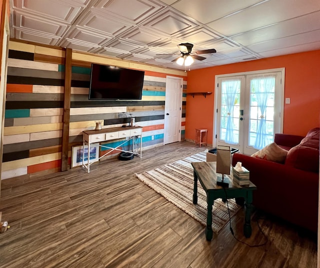 living room featuring french doors, wood finished floors, an ornate ceiling, and a ceiling fan