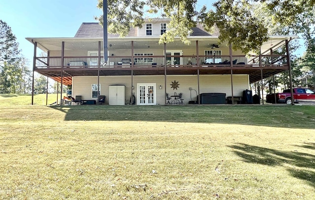 rear view of house with a deck and a lawn