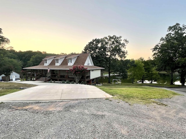 view of front of house featuring covered porch and a front yard