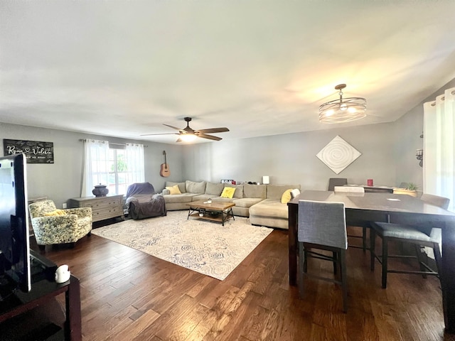 living area featuring dark wood-style floors and a ceiling fan