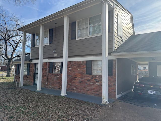 view of side of home featuring brick siding