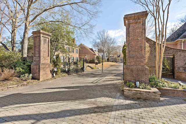 view of road with a residential view and a gate