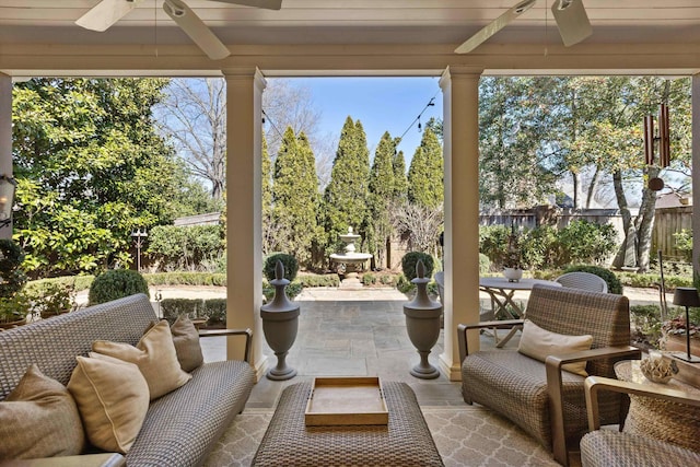 sunroom with plenty of natural light and a ceiling fan