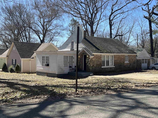 view of property exterior with stone siding and a chimney