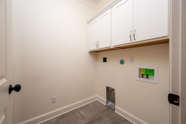 clothes washing area featuring baseboards, hookup for a washing machine, cabinet space, and hookup for an electric dryer