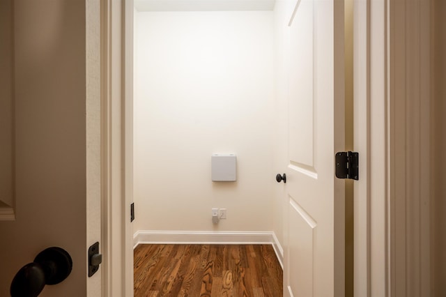 laundry area with baseboards and dark wood finished floors