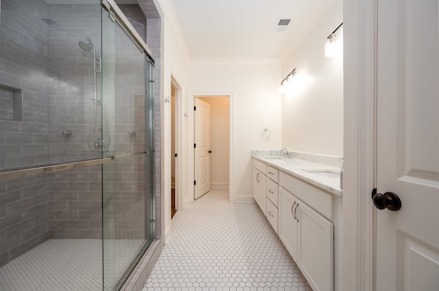 bathroom with ornamental molding, a sink, a shower stall, and double vanity