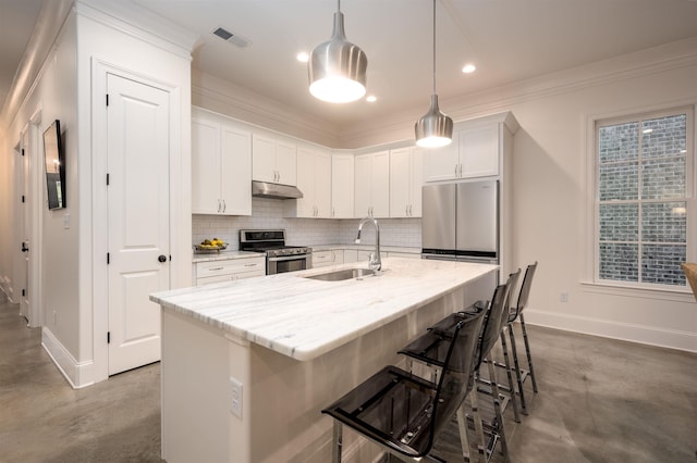 kitchen with finished concrete flooring, decorative backsplash, stainless steel appliances, under cabinet range hood, and a sink