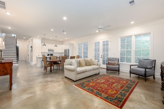 living room with stairs, french doors, visible vents, and finished concrete floors