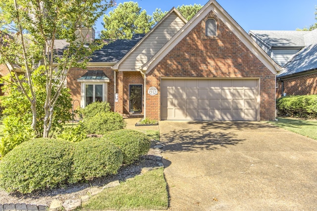 view of front of property with a garage, concrete driveway, and brick siding