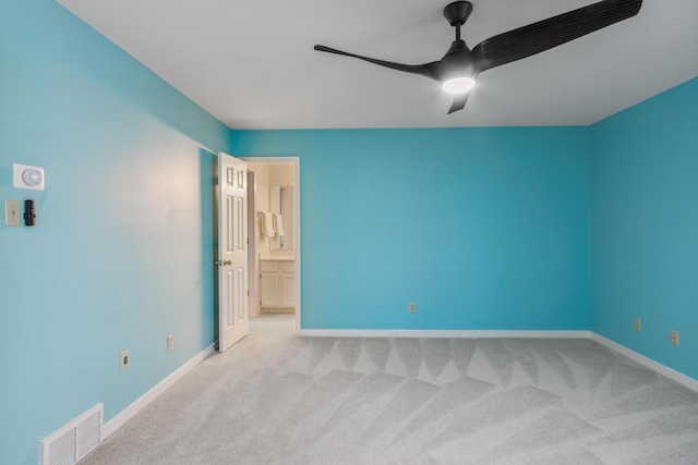 spare room with carpet, visible vents, ceiling fan, and baseboards