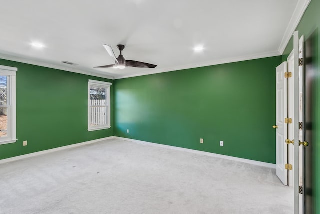 carpeted spare room featuring baseboards, visible vents, and ornamental molding