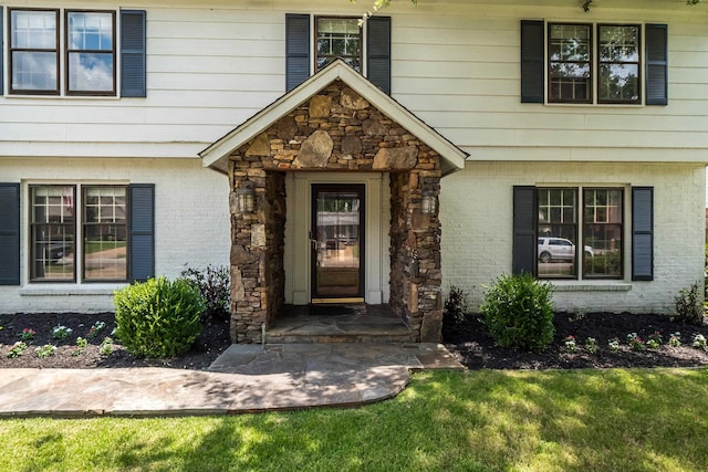 entrance to property with stone siding and brick siding