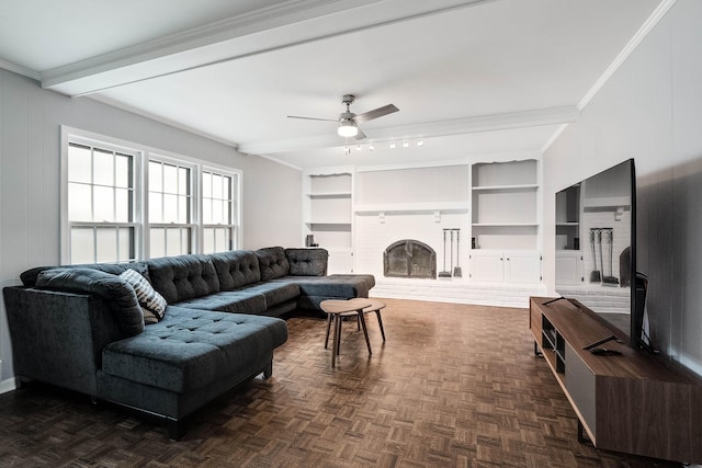 living area with a fireplace with raised hearth, crown molding, beam ceiling, and built in features