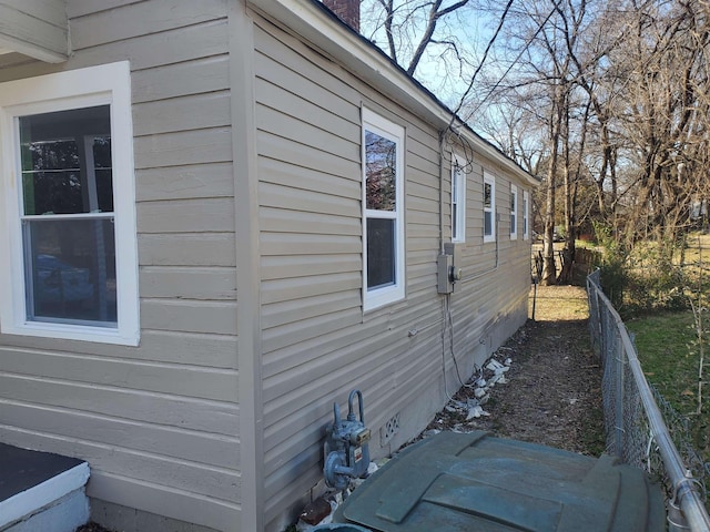 view of home's exterior featuring crawl space and fence