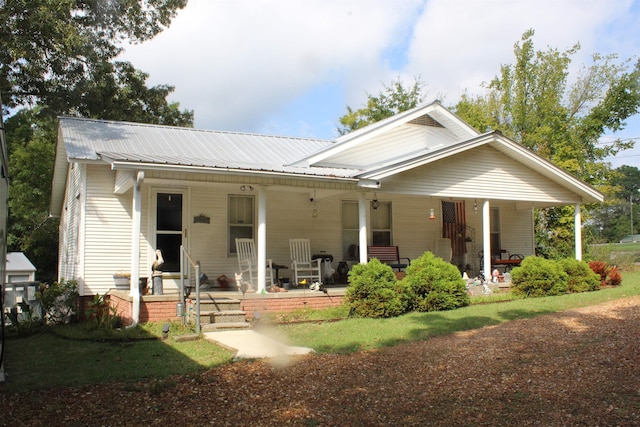 view of front of house featuring covered porch and metal roof