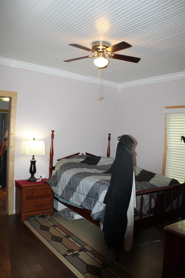 bedroom featuring a ceiling fan, wood-type flooring, and crown molding