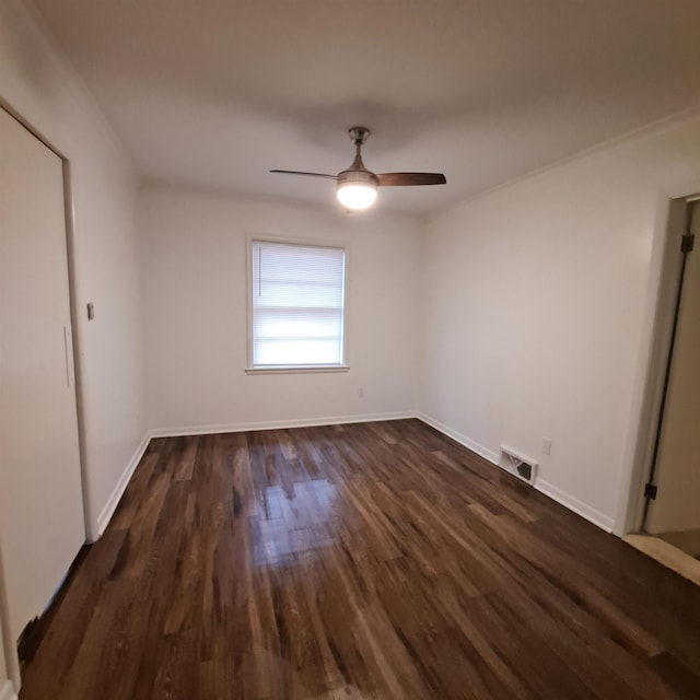 unfurnished bedroom with dark wood-type flooring, baseboards, ceiling fan, and visible vents