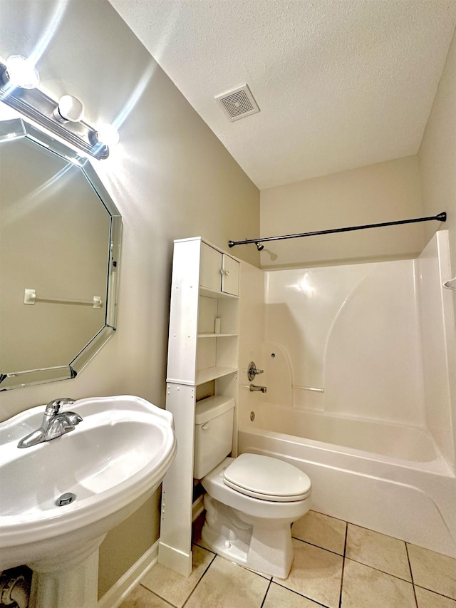 bathroom with toilet, a sink, visible vents, tub / shower combination, and tile patterned floors