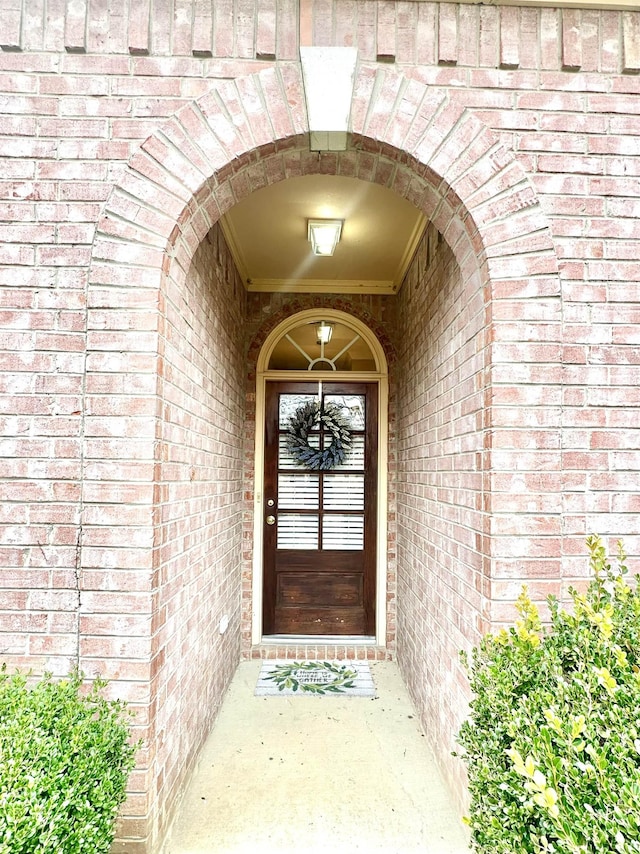 property entrance featuring brick siding