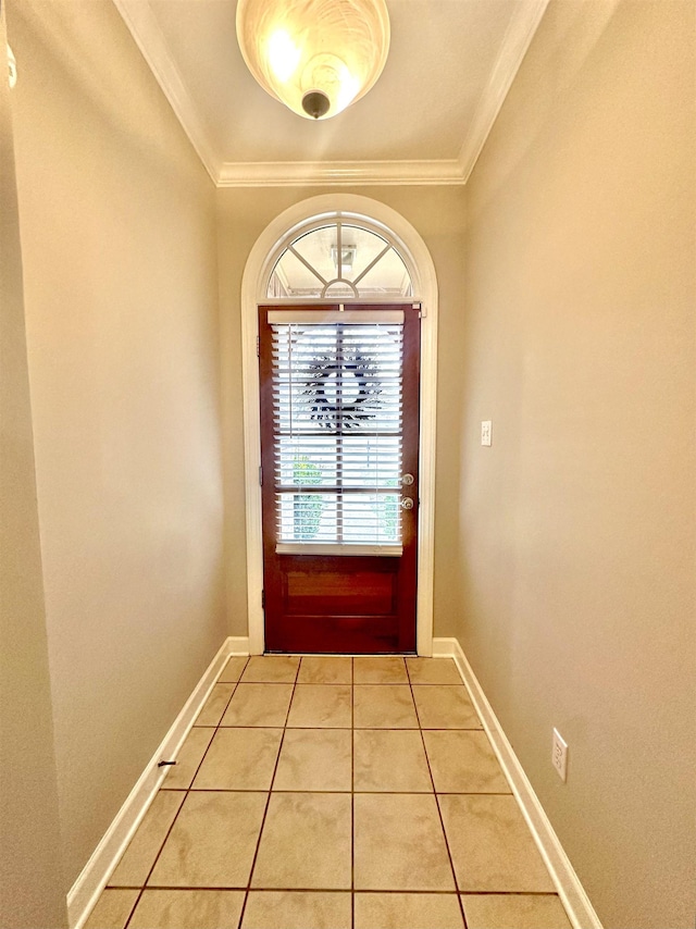 doorway to outside featuring light tile patterned floors, baseboards, and crown molding