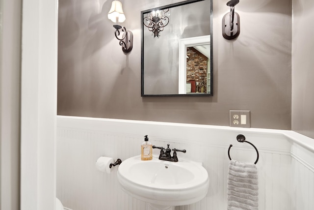 bathroom with wainscoting and a sink