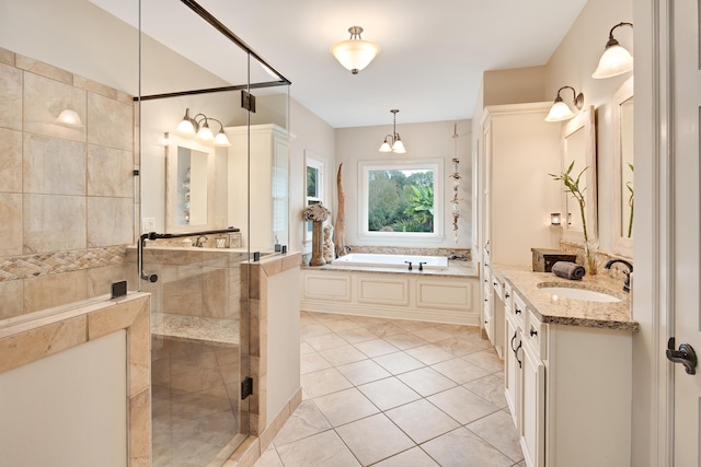 bathroom featuring a stall shower, tile patterned flooring, a garden tub, and vanity