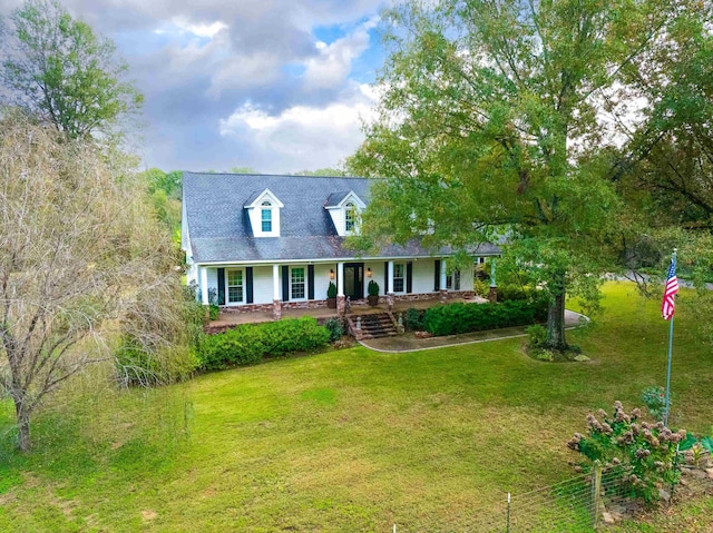 cape cod house featuring a front lawn and a porch