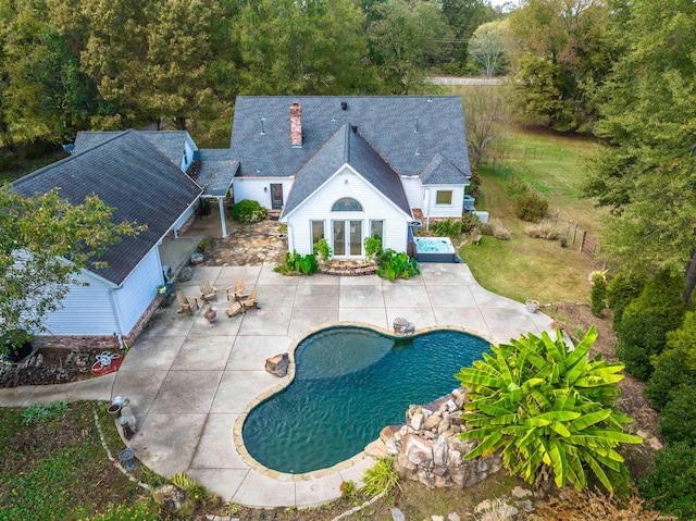 outdoor pool featuring a patio area and fence