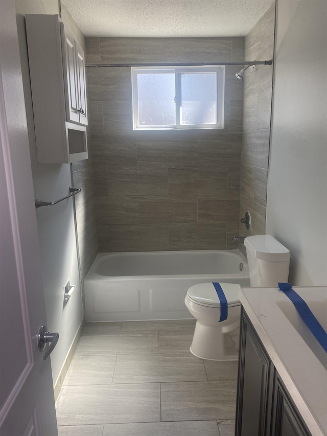 bathroom featuring shower / bath combination, a textured ceiling, toilet, and vanity