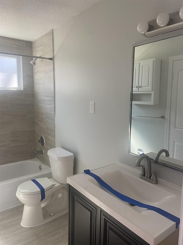 full bathroom with toilet, shower / tub combination, a textured ceiling, and vanity
