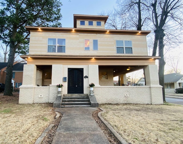 traditional style home featuring brick siding and covered porch