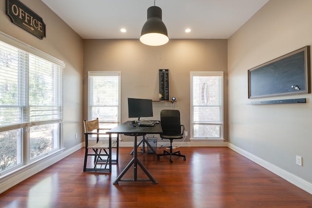 office space with plenty of natural light, wood finished floors, and baseboards