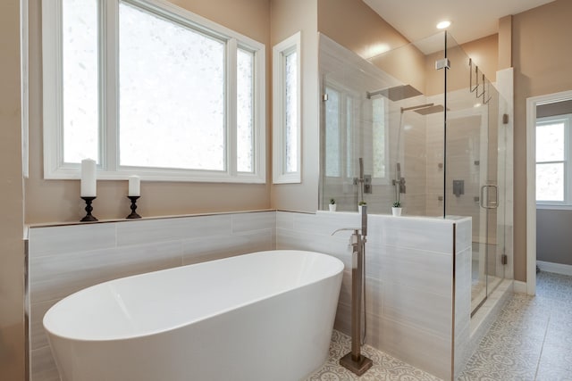 full bathroom with a stall shower, tile patterned flooring, and a freestanding bath