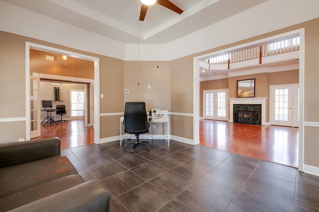 office area with a high end fireplace, dark tile patterned flooring, french doors, and baseboards