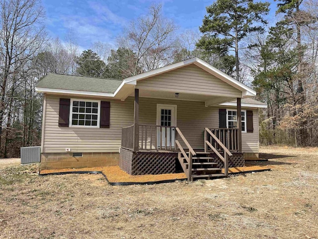 view of front of property featuring a porch, crawl space, roof with shingles, and central AC