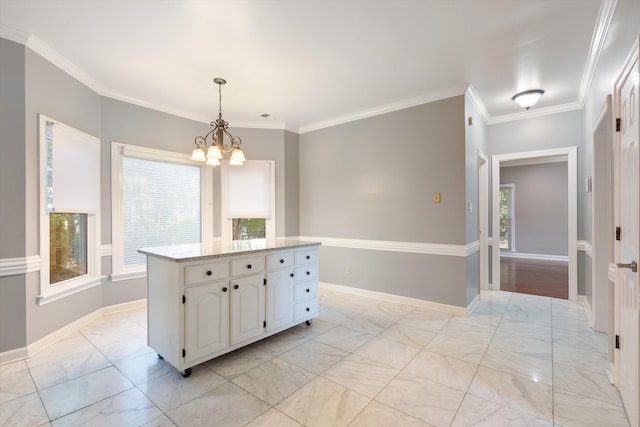 interior space with ornamental molding, a wealth of natural light, and white cabinets