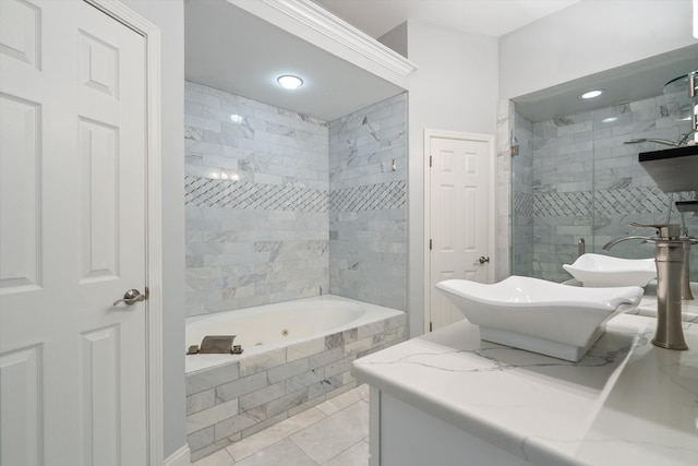 full bath featuring a tile shower, vanity, and a whirlpool tub