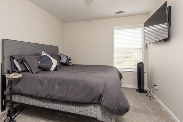 bedroom featuring baseboards, visible vents, and carpet flooring