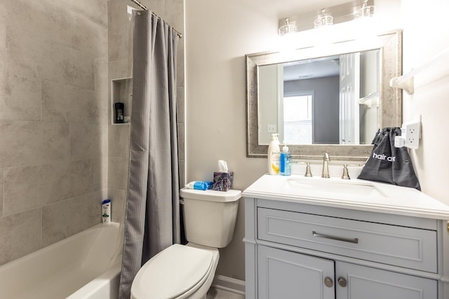 full bathroom featuring vanity, shower / bath combo with shower curtain, and toilet