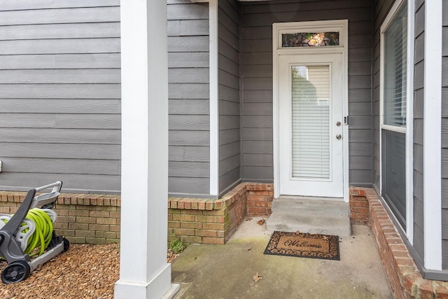 entrance to property featuring brick siding