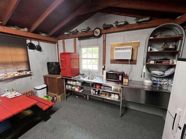 kitchen with carpet, vaulted ceiling, a wall unit AC, and a sink