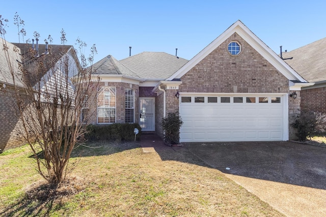 view of front of home with a garage, brick siding, driveway, and roof with shingles