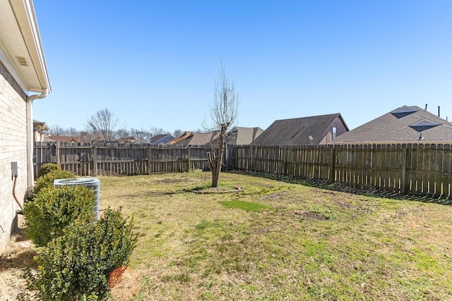 view of yard with central AC and a fenced backyard