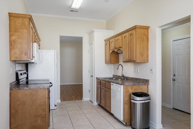 kitchen with light tile patterned floors, white appliances, a sink, visible vents, and dark countertops