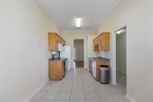 kitchen with ornamental molding, white appliances, light tile patterned floors, and a sink