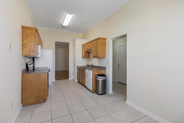 kitchen featuring ornamental molding, dark countertops, dishwasher, and a sink