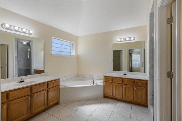 full bath with a shower stall, two vanities, a sink, and tile patterned floors