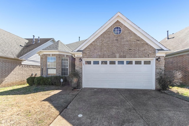 view of front of house with a garage, concrete driveway, brick siding, and a front lawn